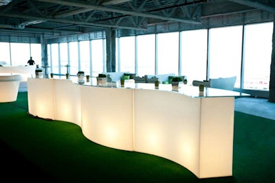 Astroturf and illuminated bars transformed the raw office space for cocktail hour.