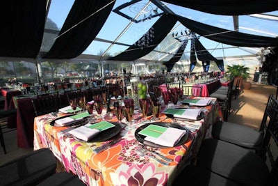 The dinner tent housed a mix of square and rectangular tables adorned with either a vibrant floral pattern or purple and green linens.