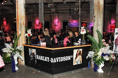 Staff at a Harley-Davidson branded information booth greeted guests as they arrived.