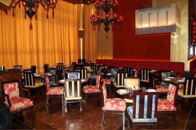 An illuminated Lucite DJ booth is suspended over the main dining room.