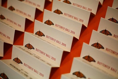 Monarch butterflies decorated name tags at the check-in table, which BBJ dressed with matching orange linens.