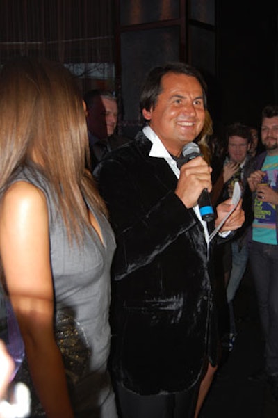 Russian Standard founder Roustam Tariko, flanked by models wearing branded cocktail dresses, addressed the crowd during the party.