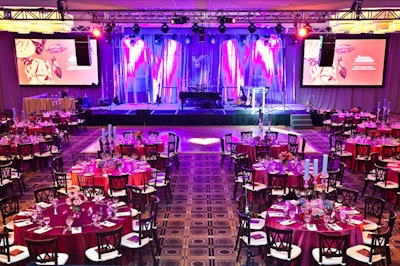 The ballroom was set up with a dining space, a dance floor, and a stage as the focal point.
