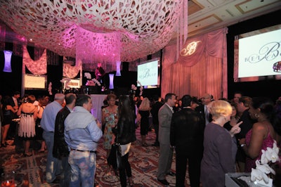 Guests mingled at the Bellagio under a dramatic chandelier for the fashion feast event.