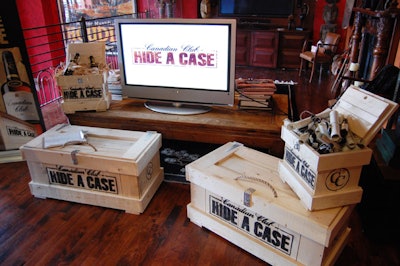 Cases of Canadian Club whisky served as a backdrop for a press conference held to announce the launch of the Hide a Case Adventure—an international treasure hunt with a $100,000 prize.