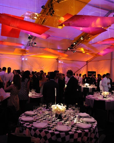 Interspersed among tables covered in white linens, 10 tablecloths were printed with imagery created by Guyton/Walker. Transparent walls on two sides of the tent allowed attendees to view the new vinyl mural from their seats.