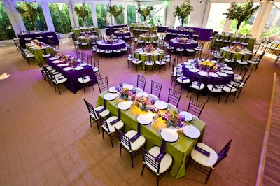 The decor in the tent included bright purple and green linens and fresh fruit or flower centerpieces.
