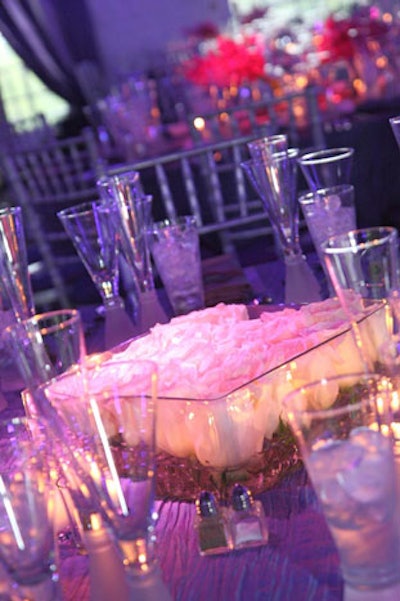 White rose centerpieces were interspersed with other pink centerpieces on the dining tables.