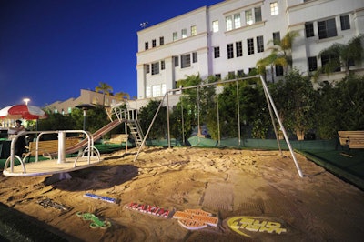 A sandbox complete with swing set and carousel decorated one part of the party space, and sponsors' logos rose from the box like sand castles.