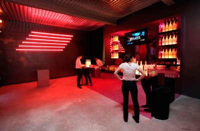 The main section of the space was designed to imitate nightclubs and provide an open enough layout for the scheduled events. Shiraz Events built freestanding bars and cloaked the raw walls with painted partitions.