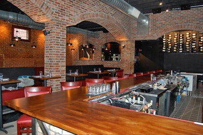 Brick arches separate the 14-seat bar from the main dining room.