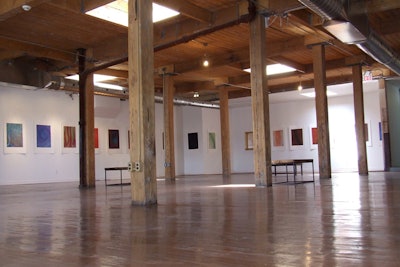Wooden beams accentuate the high ceilings and skylights provide natural light in the 5,000-square-foot gallery space.