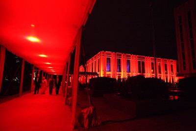 A canopied red carpet stretched from the entrance gate to the entryway of the ceremonial building.
