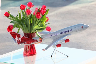 Red tulips and model airplanes topped tables.