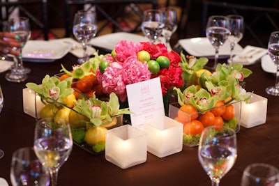 Centerpieces included flowers, fruit, and cards with details on the items up for auction.