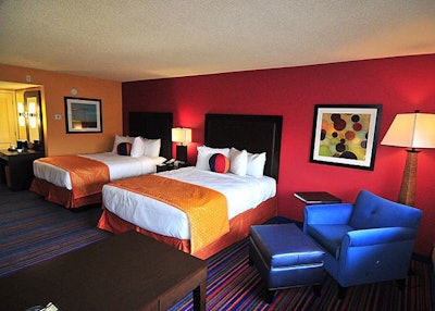 The hotel rooms spread throughout nine buildings and are decorated with bright colors.