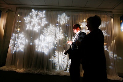 Snowflakes lit curtains along the aquarium's south corridor, which lead to the cocktail reception. Severs circulated with trays of champagne.