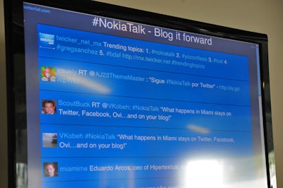 Four LCD TVs showed a live Twitter feed of the day's discussions.