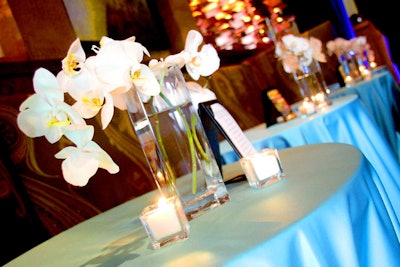 Raining Roses topped the highboy tables with white orchid centerpieces.
