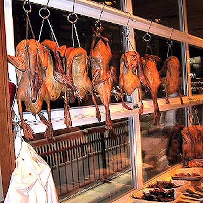 Park Avenue Cafe displayed a row of Peking duck-style carcasses suspended from steel stringers behind its tasting station that offered marinated roasted duck breast.