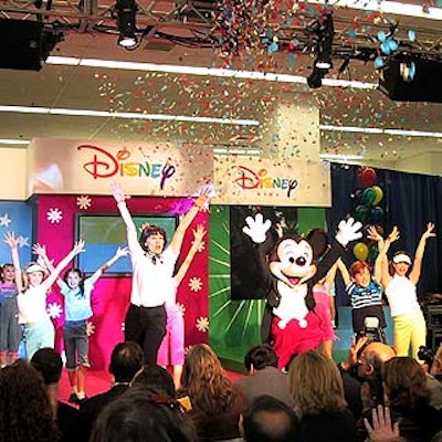 For the press launch event of Disney's new children's clothing line at the Kmart Astor Place store, Beth Leavel of the Broadway musical 42nd Street joined Mickey Mouse and some young models at the conclusion of the fashion show.