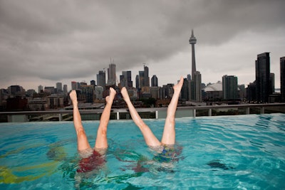 The Olympic rings—a nod to the network's coverage of the event—were affixed to the bottom of the rooftop pool, where synchronized swimmers performed for guests.
