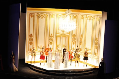 Set atop a massive rotating platform, the board of directors' special tribute award to the late Alexander McQueen was the night's most technically challenging aspect. The live fashion presentation involved 16 models walking onto a set that revolved to reveal a French drawing room-inspired vignette complete with a Swarovski chandelier.
