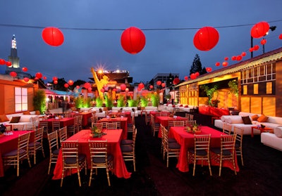 Red cloths covered tables and lighting illuminated foliage from below.
