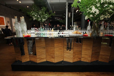 A four-sided mirror bar, topped with towering Japanese dogwood arrangements, served cocktails from sponsors Belvedere and Grand Marnier.