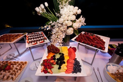 Dessert tables included offerings like colorful fresh fruit, plus monochromatic white floral arrangements.