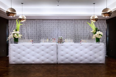 White flowers topped a white quilted bar.