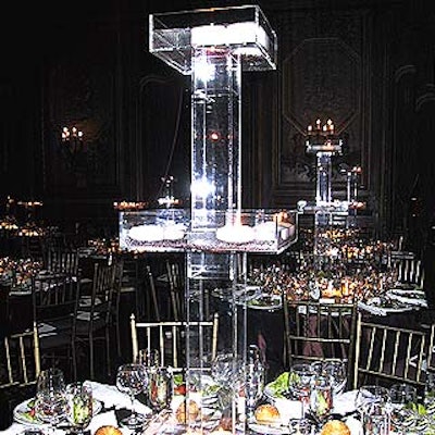 Antony Todd's multi-tiered centerpieces had clear Lucite boxes filled with white floating candles and tiny gold glittery pebbles.
