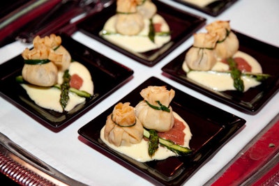 Servers passed mini plates from Liberty Entertainment Group Catering with dishes like wild mushroom beggar's purses served with grilled asparagus, rhubarb compote, and hollandaise sauce.