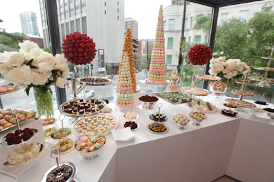 New-York-based caterer Olivier Cheng prepared a buffet of French desserts. Offerings included strawberry topiaries, macaroon towers, rosemary-honey-almond tarts, and salted caramel mousse in chocolate cups. All Things Party created a custom dessert bar that would fit into the window overlooking Rush and Oak streets.