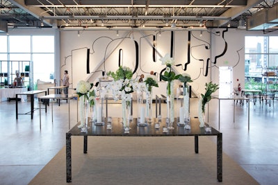 Louis's graffiti-inspired logo wall set the backdrop for the sleek white party space.