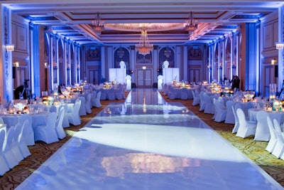 The white dance floor, which Tom Kehoe called a 'runway dance floor,' was 117 feet long. Kehoe described his palette as 'a clean, crisp white slate with hazy blue lighting and touches.'