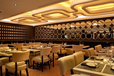 The 46-seat dining room has dark brown walls and ivory leather seating.