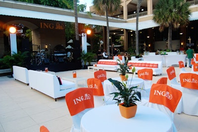 Orange and white tables, chairs, and sofas provided seating during the cocktail reception in the zoo's pavilion space.