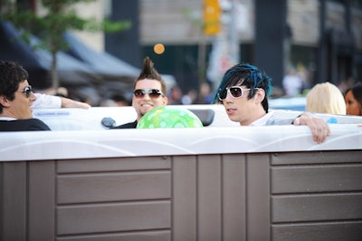 The band Marianas Trench, dressed in full suits, arrived in a hot tub full of water.