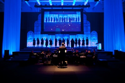 Women from the Founders' Chorus—which includes faculty, students, and alumni—sang before dinner. Instead of using two screens, planners settled for a single large one, saving money on projectors.