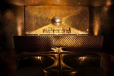 Decor includes gilding and leather. The bar simulates the look of a camera flash.
