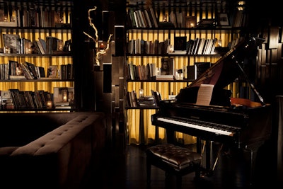 A grand piano and books fill the Library Room.