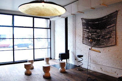 A recycled satellite dish covered in gold leaf hangs from the ceiling in the foyer, which also features a Morso fireplace from Denmark.