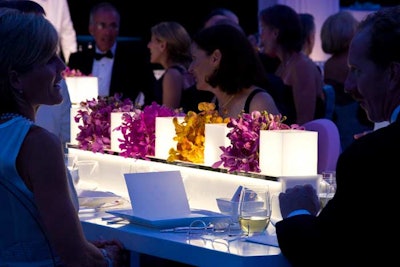 Heffernan's four-foot-long centerpieces incorporated glowing white Lucite cubes and color blocks of raspberry, gold, and purple orchids.