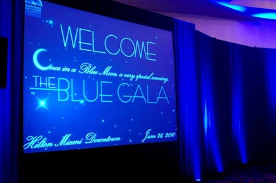 The event's blue theme extended to the stage draping, lighting, and large projection screens that showed sponsor logos.