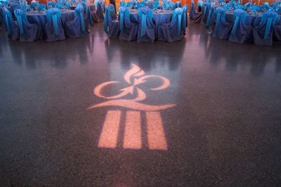 Patterned lighting cast the association's logo on the floor.