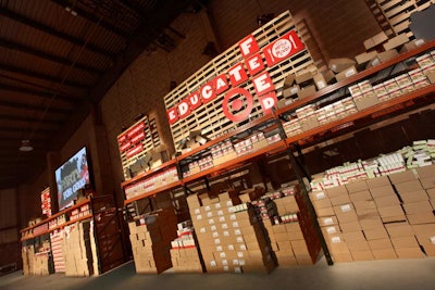 During the six-day build-out, the production team constructed the stage and stations, and stacked all the food supplies on shelves. The design was simple and played up the raw nature of the warehouse with metal racks and tables, cocktail tables covered in corrugated cardboard, and wooden pallets decorating the walls.