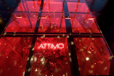 A 22- by 24-foot dance floor was erected over the venue's existing pool. Drained of water, the recessed space held a neon Attimo sign surrounded by dried flowers.