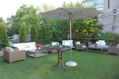 Red flower arrangements accented the furnishings on the rooftop terrace at Andrew Richard Designs.