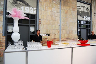 Bartenders offered Piper Heidsieck champagne to guests at a long white bar in the reception area.